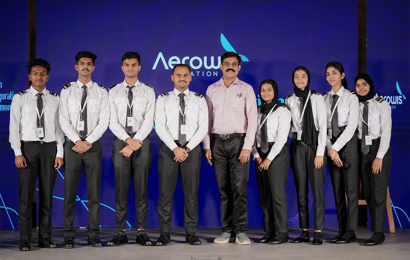 Aerowis students in uniform gathered on stage at a batch inauguration ceremony